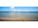 Clear, shallow waterfront view on a sunny day with clear blue skies and faint city views on the horizon at 322 S Washington Dr, Sarasota, FL 34236