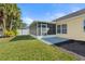 Spacious backyard featuring a screened-in lanai area and lush green lawn at 3413 5Th W Dr, Palmetto, FL 34221
