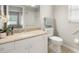 This well-lit bathroom features a granite vanity, a modern toilet, and a shower with sleek white tiling at 3413 5Th W Dr, Palmetto, FL 34221