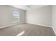 This neutral bedroom boasts carpeted floors, a large arched window, and plenty of space to make it your own at 3413 5Th W Dr, Palmetto, FL 34221