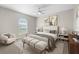 This stylish bedroom features lots of natural light and a cozy sitting area with a comfortable upholstered chair at 3413 5Th W Dr, Palmetto, FL 34221