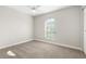 This neutral bedroom offers a large arched window for natural light, carpet flooring, and a spacious closet at 3413 5Th W Dr, Palmetto, FL 34221