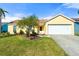Charming yellow home with a well-manicured lawn and beautiful landscaping at 3413 5Th W Dr, Palmetto, FL 34221