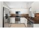 Bright kitchen features stainless steel appliances, white cabinetry, and mosaic tile backsplash at 3413 5Th W Dr, Palmetto, FL 34221