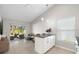 Bright kitchen with white cabinets, island, and access to screened patio at 3413 5Th W Dr, Palmetto, FL 34221