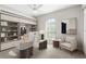 The office is designed for productivity, with a large desk, stylish chair, custom built-ins, and a window for natural light at 3413 5Th W Dr, Palmetto, FL 34221