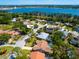 Aerial view of a neighborhood with lovely homes near a body of water, boasting mature trees at 3786 Surrey Ln, Sarasota, FL 34235