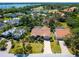 Aerial view of home with tile roof, screened in lanai and pool, surrounded by lush landscaping and trees at 3786 Surrey Ln, Sarasota, FL 34235