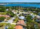 An aerial view of the property highlighting the home's pool, close proximity to the water and surrounding community at 3786 Surrey Ln, Sarasota, FL 34235