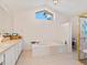 Bathroom featuring tiled floors, soaking tub, and separate shower enclosure at 3786 Surrey Ln, Sarasota, FL 34235