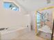Bright bathroom with tiled floors, soaking tub, and separate shower with seating at 3786 Surrey Ln, Sarasota, FL 34235