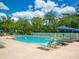 A beautiful community pool with lounge chairs and umbrellas to relax at 3786 Surrey Ln, Sarasota, FL 34235