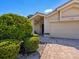 A front exterior view of the house displaying brick pavers and manicured landscaping, creating a welcoming entrance at 3786 Surrey Ln, Sarasota, FL 34235