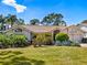 Charming single-story home with well-manicured lawn and mature landscaping creating great curb appeal at 3786 Surrey Ln, Sarasota, FL 34235