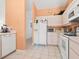 Clean kitchen with white appliances, tile flooring, and bright lighting at 3786 Surrey Ln, Sarasota, FL 34235