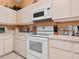 Bright kitchen featuring white appliances, ample countertop space, and plentiful cabinet storage at 3786 Surrey Ln, Sarasota, FL 34235