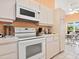 White kitchen with modern appliances and bright breakfast nook overlooking the patio at 3786 Surrey Ln, Sarasota, FL 34235