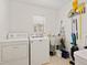 Well-equipped laundry room boasts a washer, dryer, utility sink, and ample storage space at 3786 Surrey Ln, Sarasota, FL 34235
