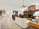 Spacious living room with a wet bar, fireplace, wood details, and tile flooring at 3786 Surrey Ln, Sarasota, FL 34235