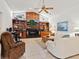 Open-concept living room with a fireplace, wood trim, and cozy seating at 3786 Surrey Ln, Sarasota, FL 34235