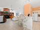 Open-concept living area with kitchen, barstool seating, and media center at 3786 Surrey Ln, Sarasota, FL 34235