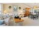 Cozy living room featuring vaulted ceilings, floral sofa set, and natural light at 3786 Surrey Ln, Sarasota, FL 34235