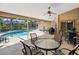 Inviting screened-in pool area boasts a sun-soaked pool, ample seating, and a tranquil outdoor space at 3786 Surrey Ln, Sarasota, FL 34235