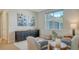 Comfortable sitting room featuring blue accents, ample natural light, and a view of the garage at 3811 158Th Avenue E Cir, Parrish, FL 34219