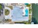 Stunning aerial view showcasing the home's backyard pool, patio, circular driveway, and waterfront location at 3941 14Th Ne Ln, St Petersburg, FL 33703