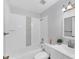 Bathroom features a shower-tub combination with white tile surround, and vanity at 3941 14Th Ne Ln, St Petersburg, FL 33703