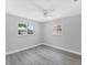 Bedroom has two windows and stylish gray wood-look flooring at 3941 14Th Ne Ln, St Petersburg, FL 33703