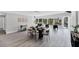 Bright dining area with a modern table, chairs, a bar cart, and views of the outdoor canal and pool area at 3941 14Th Ne Ln, St Petersburg, FL 33703