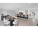 Open-concept dining area featuring a modern table, seating, and a view of the kitchen and island at 3941 14Th Ne Ln, St Petersburg, FL 33703