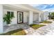 Inviting covered entrance with stylish pavers and landscaping, offering a warm welcome at 3941 14Th Ne Ln, St Petersburg, FL 33703