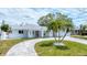 Charming single-story home with a well-manicured lawn and circular driveway, showcasing curb appeal at 3941 14Th Ne Ln, St Petersburg, FL 33703