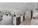 Bright, open kitchen with a wine fridge, marble countertops, and views of the canal and outdoor dining area at 3941 14Th Ne Ln, St Petersburg, FL 33703