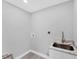 Bright laundry room features modern sink with granite countertop, and utility connections at 3941 14Th Ne Ln, St Petersburg, FL 33703