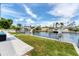 Backyard waterfront view with lush green lawn and easy access to the water for boating activities at 3941 14Th Ne Ln, St Petersburg, FL 33703