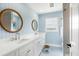 Bathroom with double vanity and patterned wallpaper at 4104 Las Palmas Way, Sarasota, FL 34238