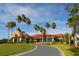 The clubhouse features a tile roof, covered entrance, and lush landscaping at 4104 Las Palmas Way, Sarasota, FL 34238
