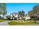 Stunning two-story white home with well-manicured front yard and circular driveway at 4104 Las Palmas Way, Sarasota, FL 34238
