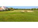 Scenic golf course view with lush green grass and a well-manicured sand trap near luxury homes at 4104 Las Palmas Way, Sarasota, FL 34238