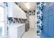 Bright laundry room featuring floral wallpaper, cabinetry, and washer/dryer units at 4104 Las Palmas Way, Sarasota, FL 34238