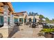 A clubhouse outdoor patio boasts seating with golf course views at 4104 Las Palmas Way, Sarasota, FL 34238