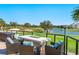 A luxury outdoor living space includes a fire pit and seating overlooking the golf course at 4104 Las Palmas Way, Sarasota, FL 34238
