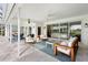 A covered patio features an outdoor living space with comfortable seating and a dining area overlooking a golf course at 4104 Las Palmas Way, Sarasota, FL 34238