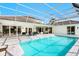 The spacious pool and patio area is perfect for entertaining, with views of the surrounding landscape at 4104 Las Palmas Way, Sarasota, FL 34238