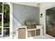 The summer kitchen features stainless steel appliances, stone backsplash, and outdoor lighting at 4104 Las Palmas Way, Sarasota, FL 34238