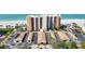 An aerial view shows the well-manicured community grounds and the impressive high-rise building at 4401 Gulf Of Mexico Dr # 907, Longboat Key, FL 34228