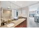 Bathroom features double sinks, granite countertop, full mirror, and access to shower and ocean view balcony at 4401 Gulf Of Mexico Dr # 907, Longboat Key, FL 34228